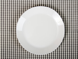 white plate on checkered table cloth - kitchen background