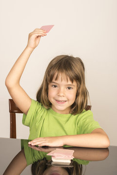 little girl playing cards