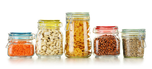 Jars with grain foods isolated on white