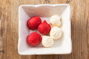Small  balls of a delicious ice-cream in a white bowl