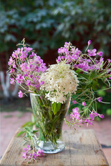 Bright summer bouquet of hydrangea and fireweed in a vase