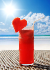 Fruity cocktail on a beach table