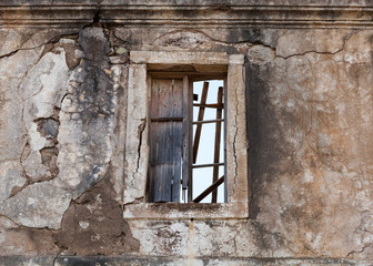 Old abandoned building facade wall with empty window