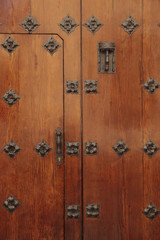 Puerta antigua decorada con detalles en hierro.