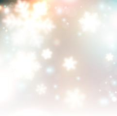 Fototapeta na wymiar White defocused snowflakes on glow background. Christmas abstrac