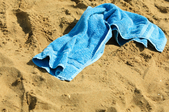 Closeup Of Blue Towel On A Sandy Beach. Relax.