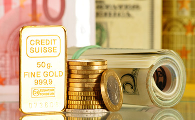 Composition with 50 gram gold bar, banknotes and coins