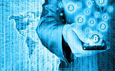 Hand with mobile smart phone and bitcoin symbol