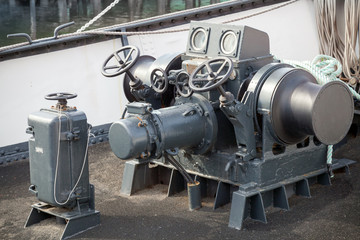 Closeup photo of bow anchor winch on ship deck