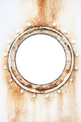 Empty round rusted porthole on white ship wall