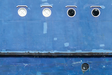 Blue hull of an old ship texture with round portholes