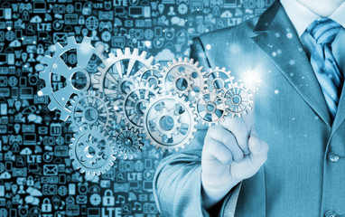 businessman hand touch  gear to success concept