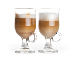 Latte coffee, two glass mugs with handles on white background