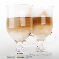 Two big glass mugs with handles of latte coffee, macro photo