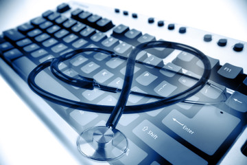 Stethoscope on computer keys keyboard. Online medical concept