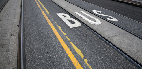 Bus label on the urban asphalt road