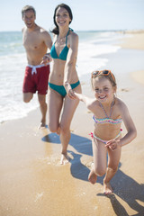 happy family in swimsuit having fun in the beach