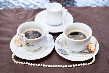 cups and pearl necklace