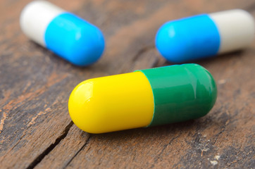 medicine capsule pill on wood background
