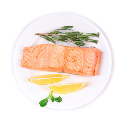 Fried salmon fillet with lemon and basil.