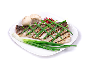 Grilled carp fillet on plate with onion.