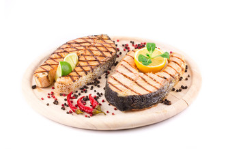 Two salmon steaks on platter.