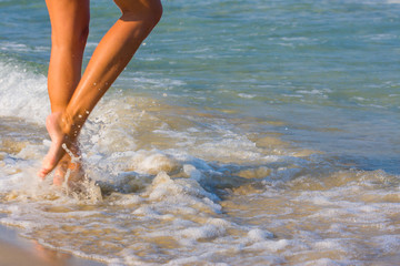 Female leg walking on the beach