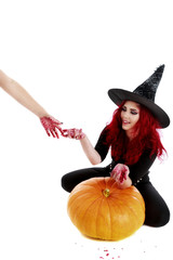 redhead witch reaches a hand full of blood