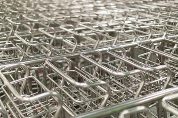 Many airport luggage carts in a row.