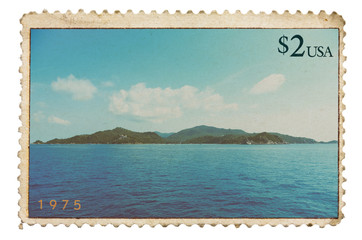 Vintage stylized postage stamp with tropical island on horizon