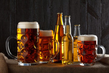 Assortment of beer glasses on table with burlap cloth