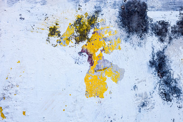Old whitewashed wall with the remains of the color print and ric