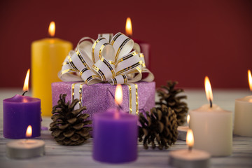 Obraz na płótnie Canvas fir-tree cones and candles on a wooden background
