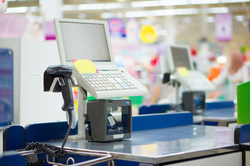 Empty cash desk with computer terminal in supermarket