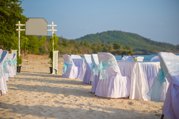 Luxury beach restaurant with tables and chairs covered with whit