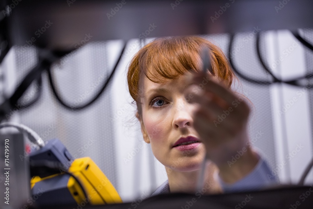 Aufkleber technician using digital cable analyzer on server