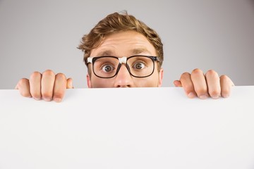 Geeky hipster showing a card