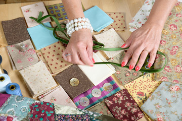 Close up of woman's hand sewing patchwork