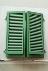 Finestre con persiane colore verde, facciata palazzo