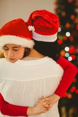 Fototapeta premium Mother and daughter hugging at christmas