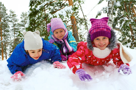 Winter fun, snow, children sledding at winter time