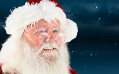 Composite image of santa claus winking