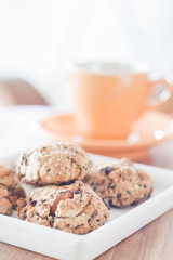 Healthy cookies on white plate with coffee cup
