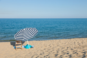 beach umbrella in front of the blue sea