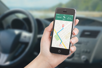 Smartphone with map gps navigation application on the screen in car