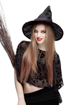 Girl in witch costume with a broom
