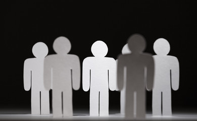 Close up of group of standing papermen, isolated 