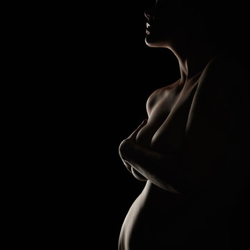 Side View Of Pregnant Woman Covering Breast While Standing Against Black  Background Photograph by Cavan Images - Fine Art America