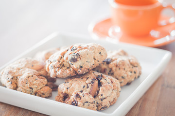 Closeup mixed nut cookies with mini orange coffee cup