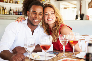 Young Couple Enjoying Meal In Outdoor Restaurant